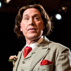 Theater company in minneapolis - a man in a suit